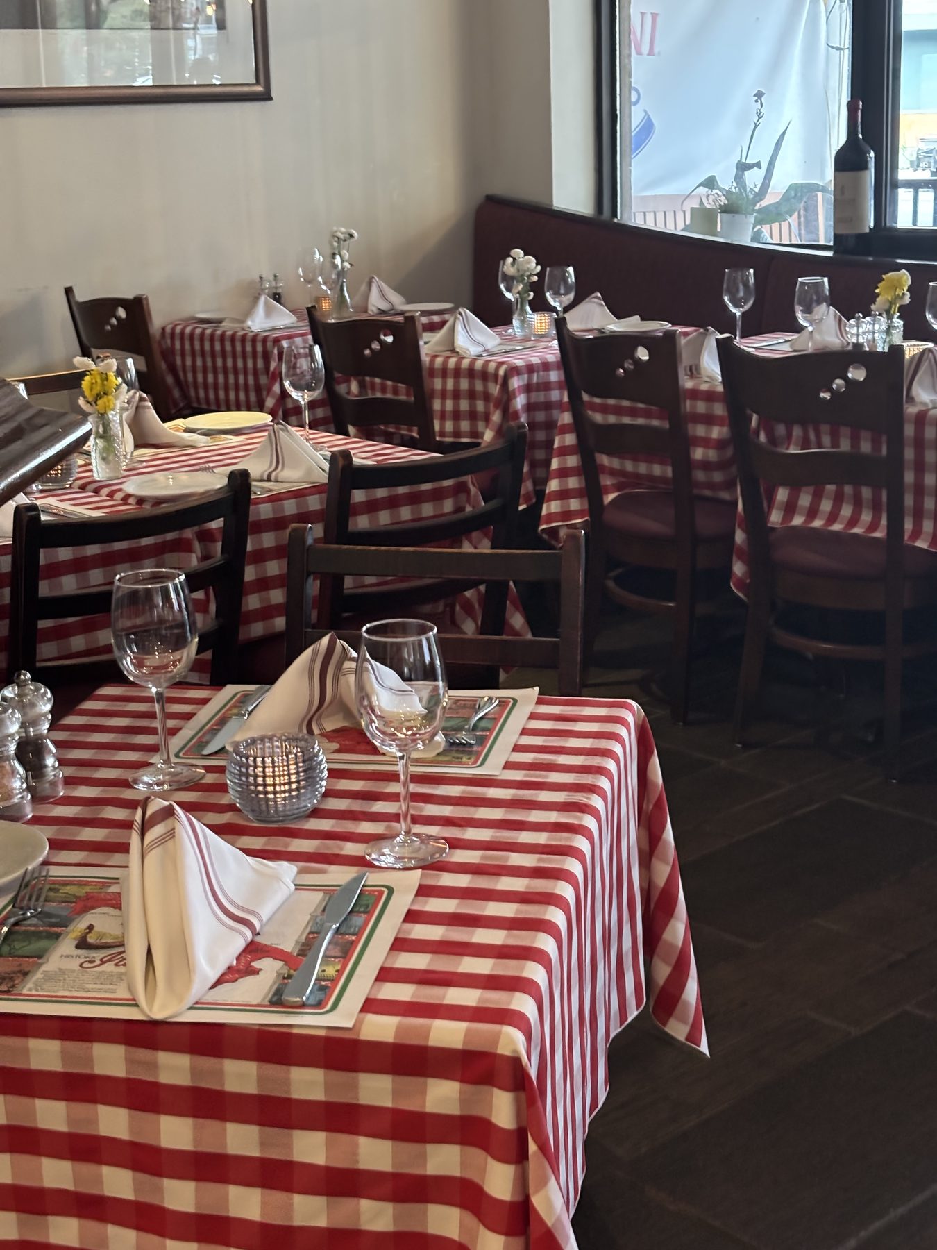 Red-checked tables set for dinner in the dining room