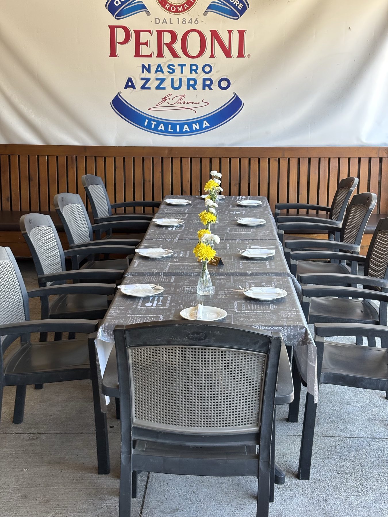 Patio tables set with flowers and place settings