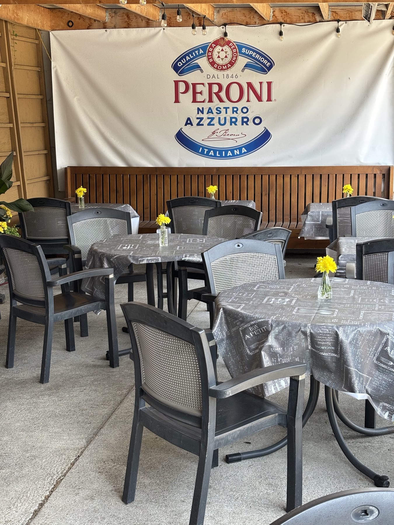 Casa Di Giorgio's outdoor patio with Peroni banner